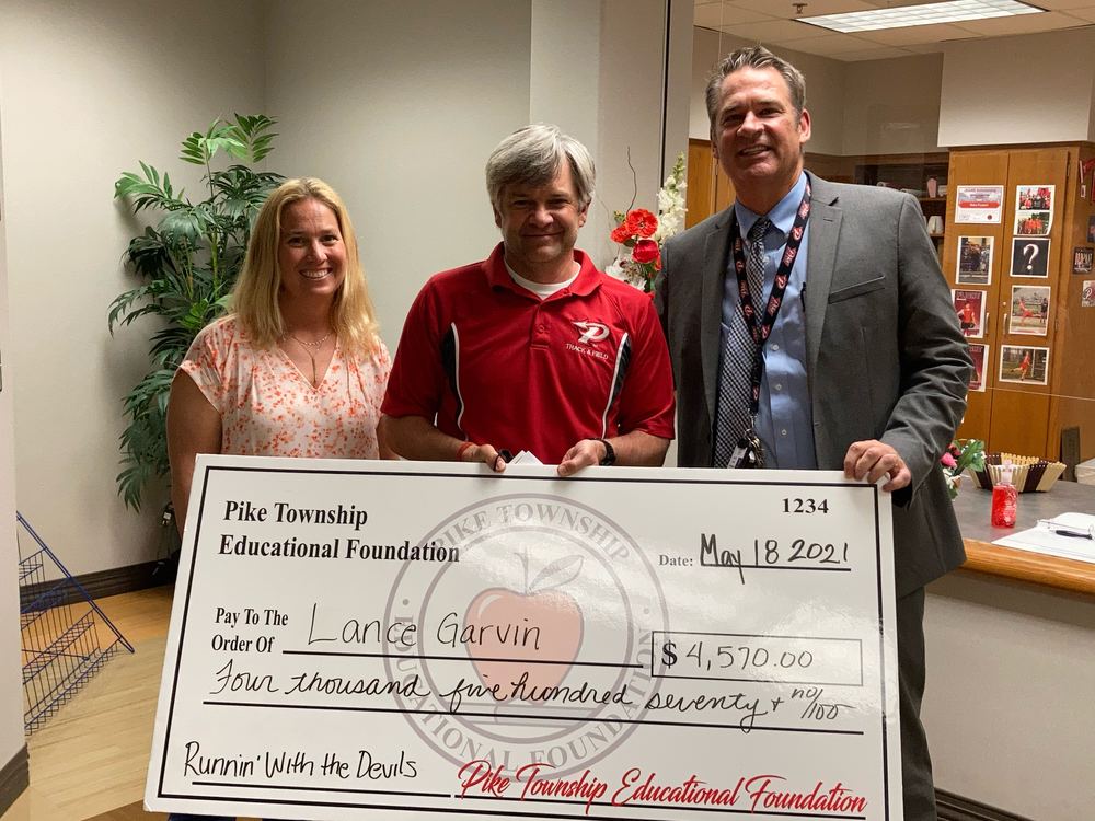 PTEF board members presenting a grant check to Pike teacher Lance Garvin