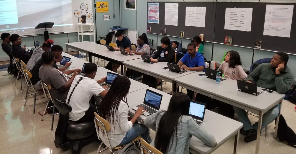 Pike students working on laptops in a classroom